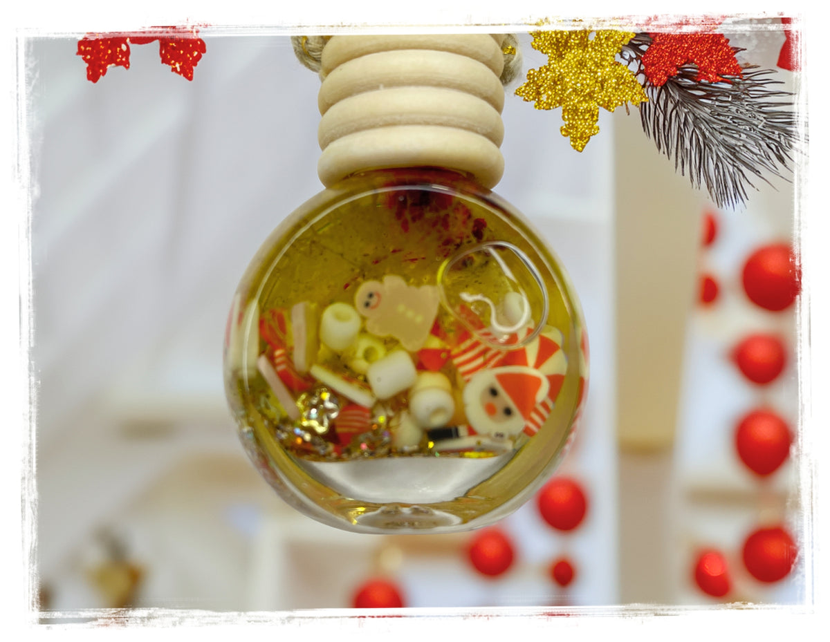 Country Christmas car charm in a round glass bottle with festive red and cream decorations and a wooden cap.