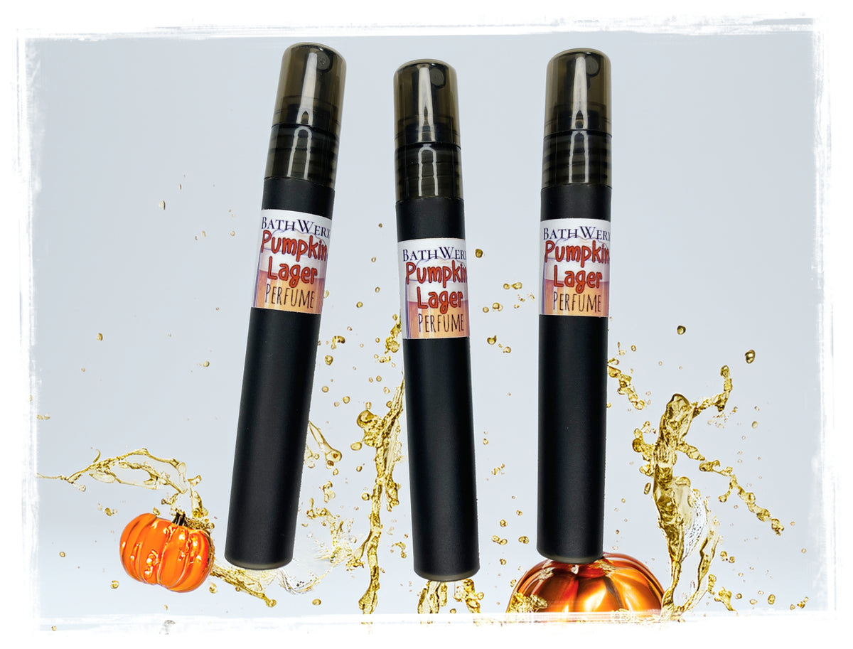 BathWerx Pumpkin Lager Perfume Spray in three sleek black pen-style bottles, with a golden liquid splash and decorative pumpkins on a light gray background.