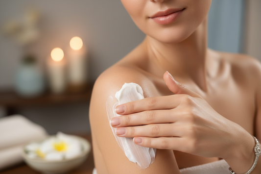 A woman applying body butter to her shoulder.