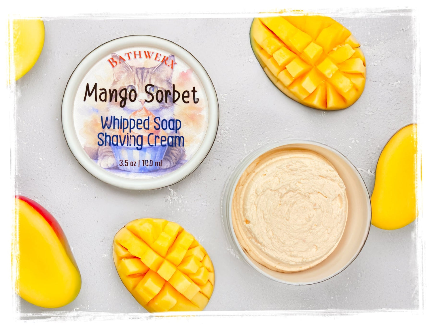 Whipped shave cream jar with mango and tropical fruit styling on white background