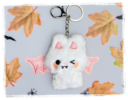 White and pink plush bat keychain with metal key ring and clasp.