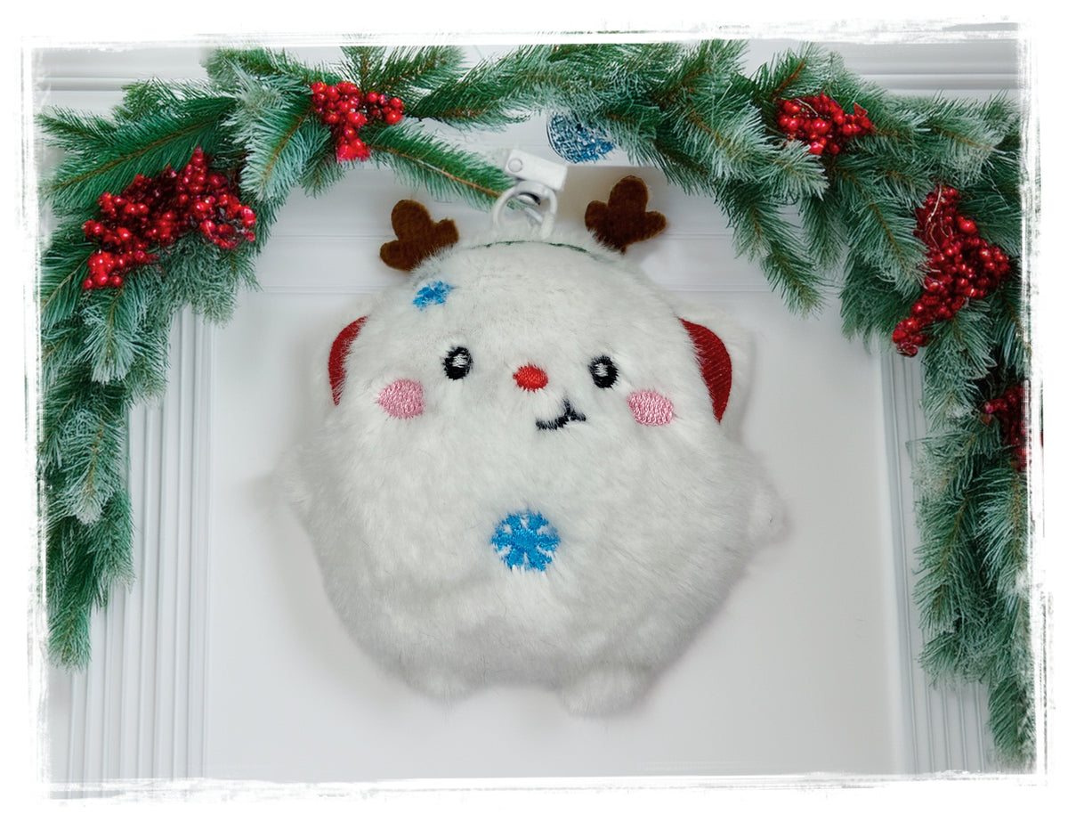 White reindeer plush Christmas keychain with blue snowflake embroidery.
