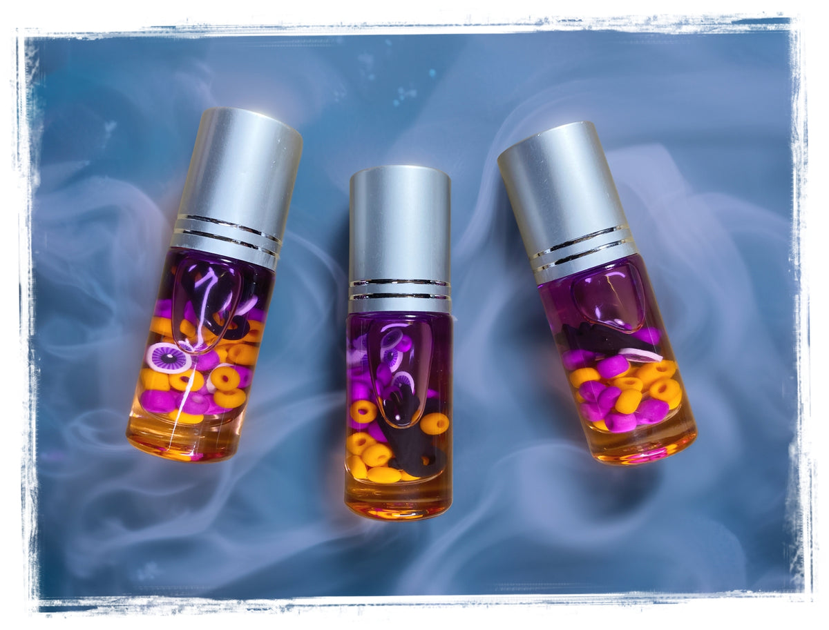 Boo Juice roll-on perfume bottles filled with purple and orange Halloween confetti, displayed on a blue background.