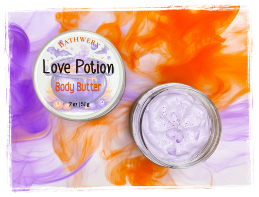 Love Potion Halloween Body Butter by BathWerx, open jar showing pale lavender butter on an orange and purple marbled background.