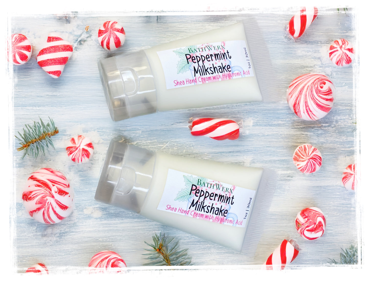 Two packages of Bath & Body Works Peppermint Milkshake Hand Cream on a wooden surface with candy-themed decorations.