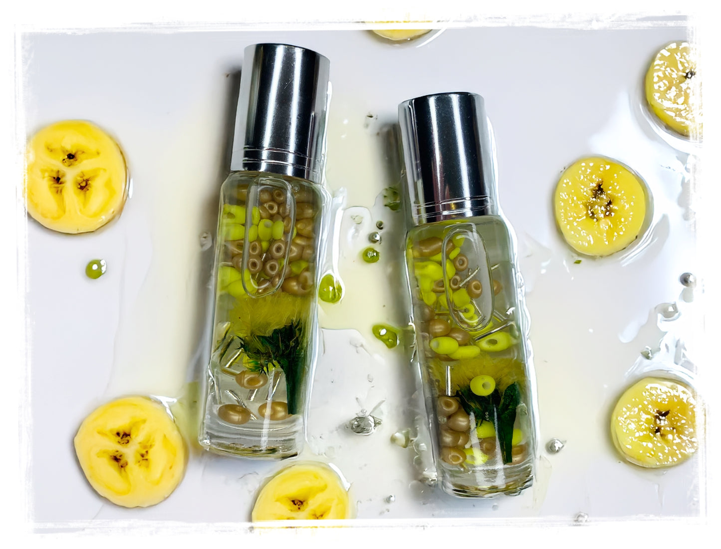 Two transparent bottles with silver caps on a white background with sliced bananas.