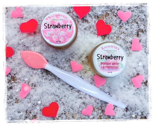 Two jars of strawberry lip moisturizer with a pink applicator on a textured surface with heart-shaped decorations.