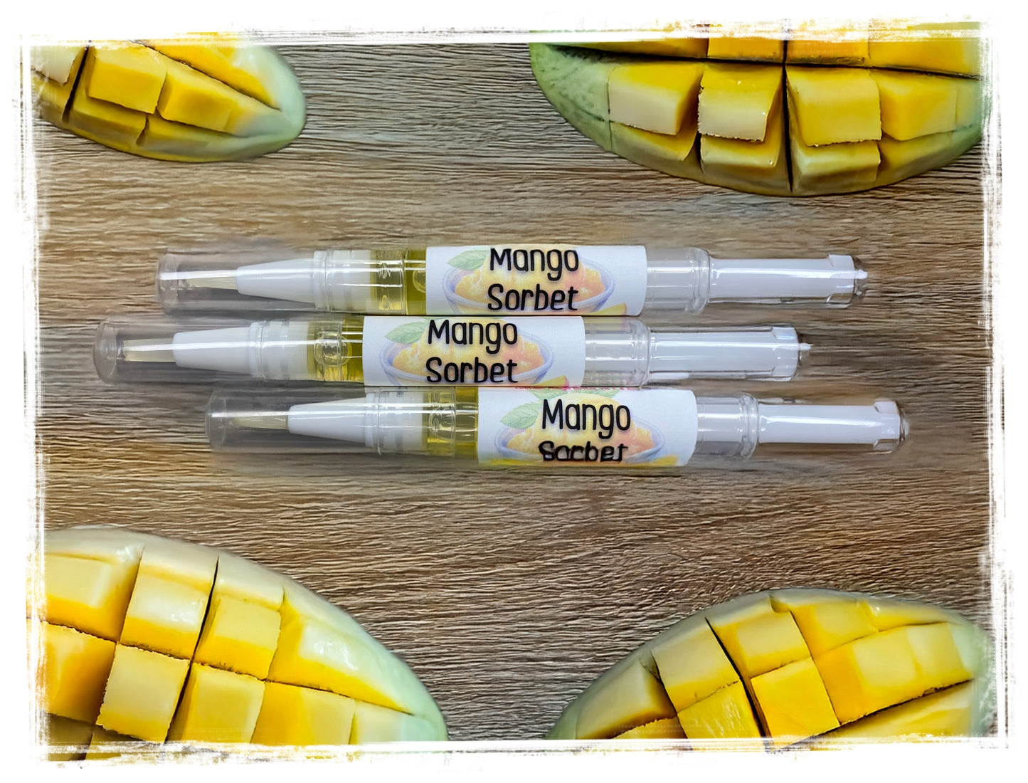 Mango Sorbet scented nail and cuticle repair pens with mango slices on wood - portable nail care treatment