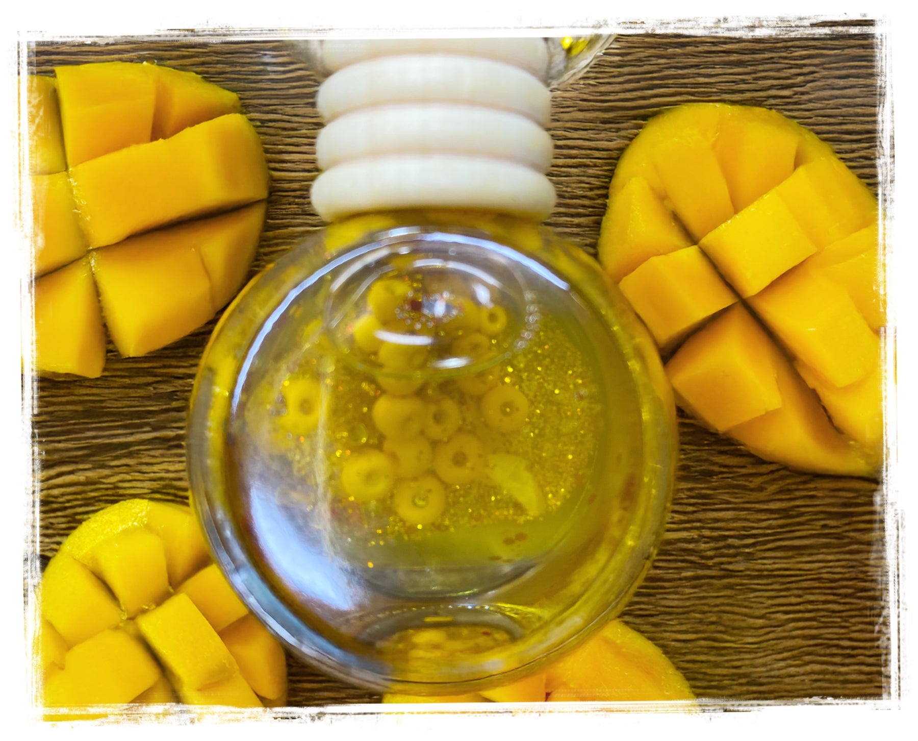 Mango scented car charm with fresh mango slices on woven surface - tropical fruit air freshener