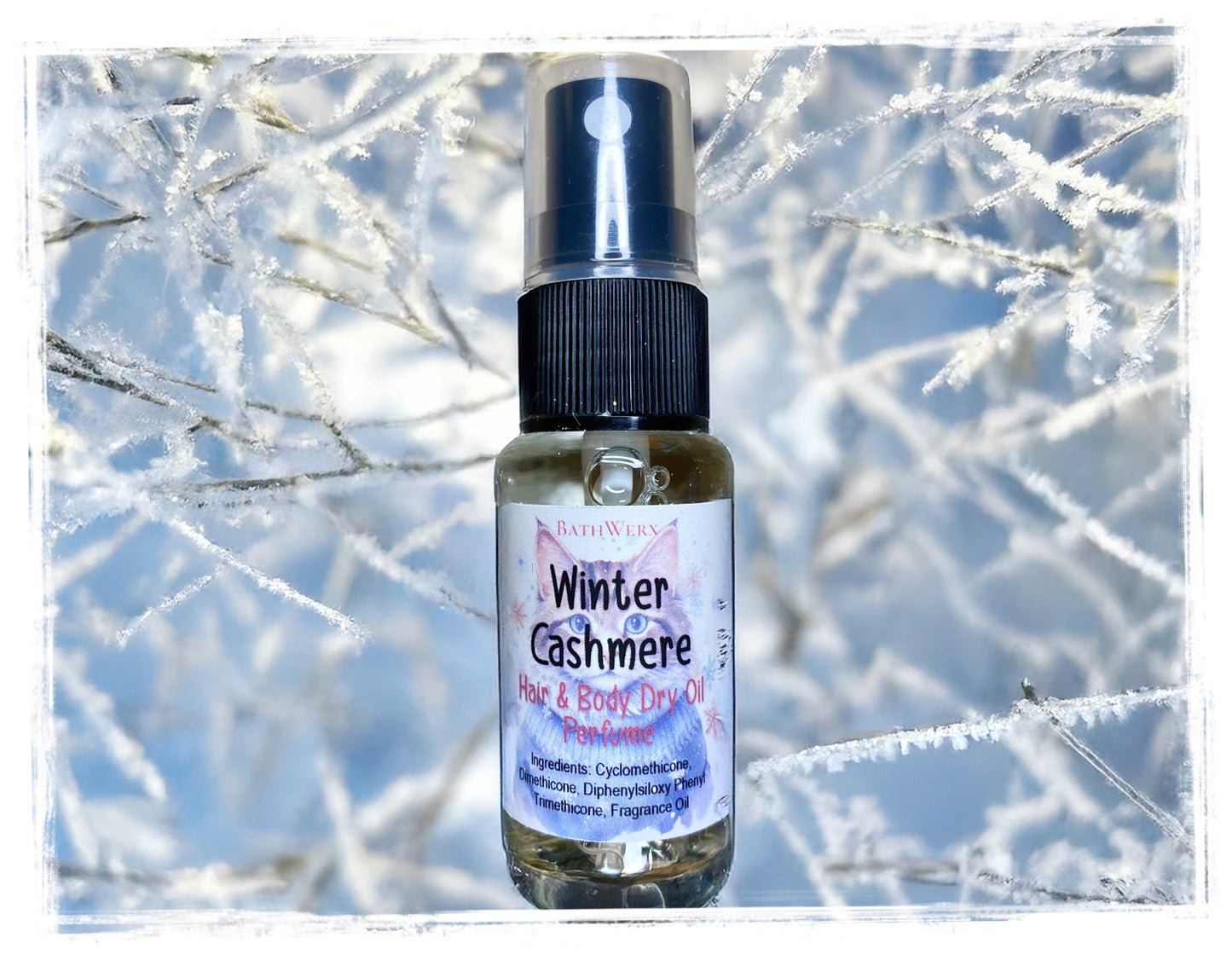 Bottle of 'Winter Cashmere' hair and body dry oil with a snowy branch background