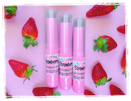 Three pink color changing lip balms with strawberry design on a pink background