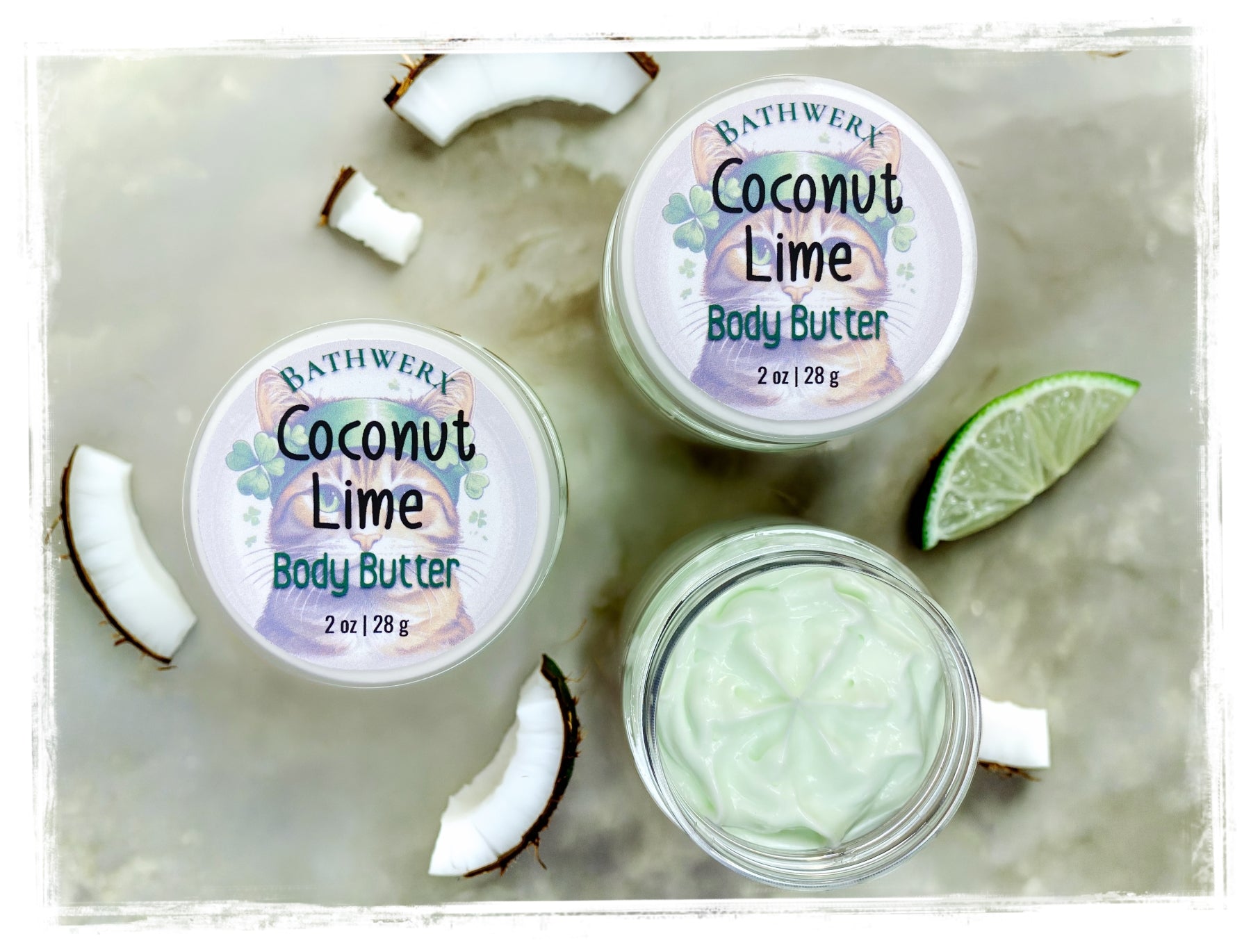 Bathwerx Coconut Lime body butter with coconut and lime slices on a marble surface