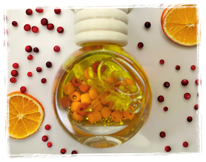 Fruit scented car charm close-up - decorative glass bead hanging air freshener in vibrant fruit fragrances