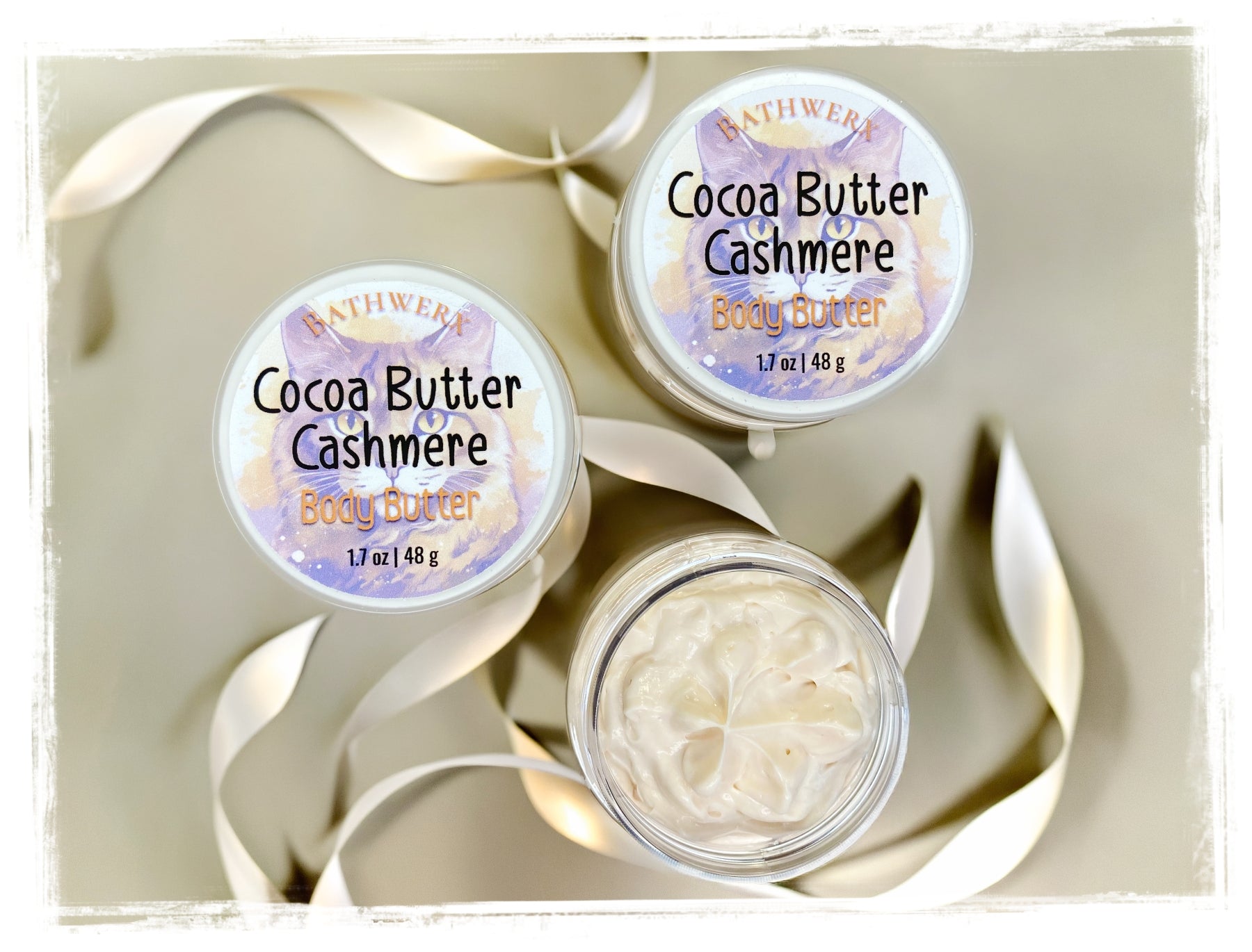 Cocoa Butter Cashmere body butter jar - luxurious hydrating moisturizer on soft cashmere surface