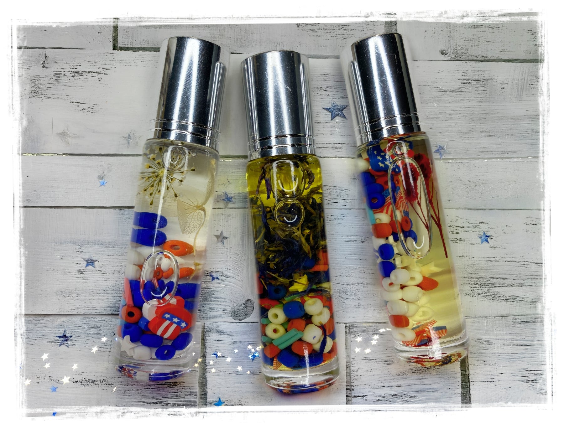 BathWerx 4th of July Roll-On Perfume Oil — three clear bottles filled with red, white, and blue patriotic charms and beads