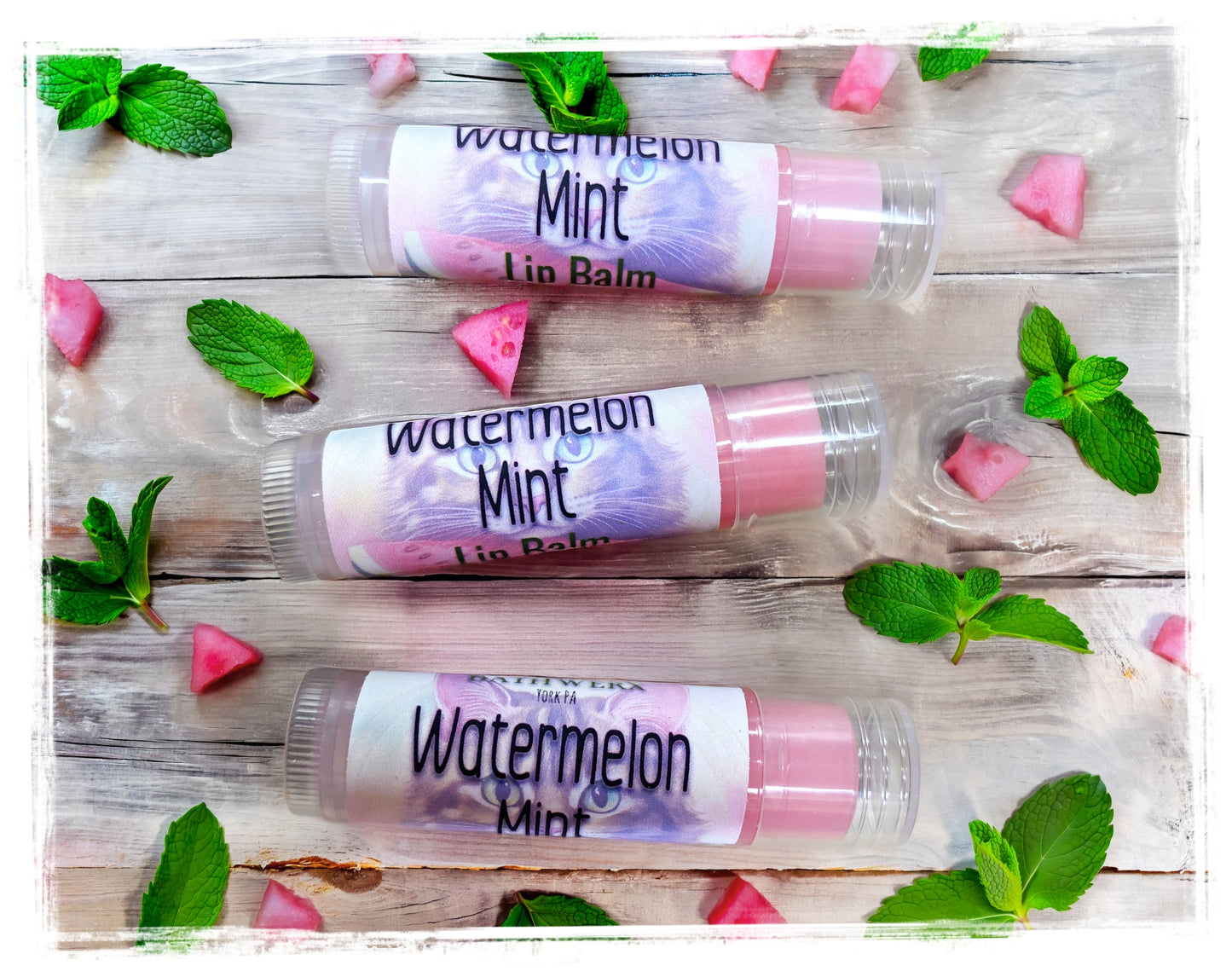 BathWerx Watermelon Mint Lip Balm three tubes flatlay with mint leaves and watermelon accents