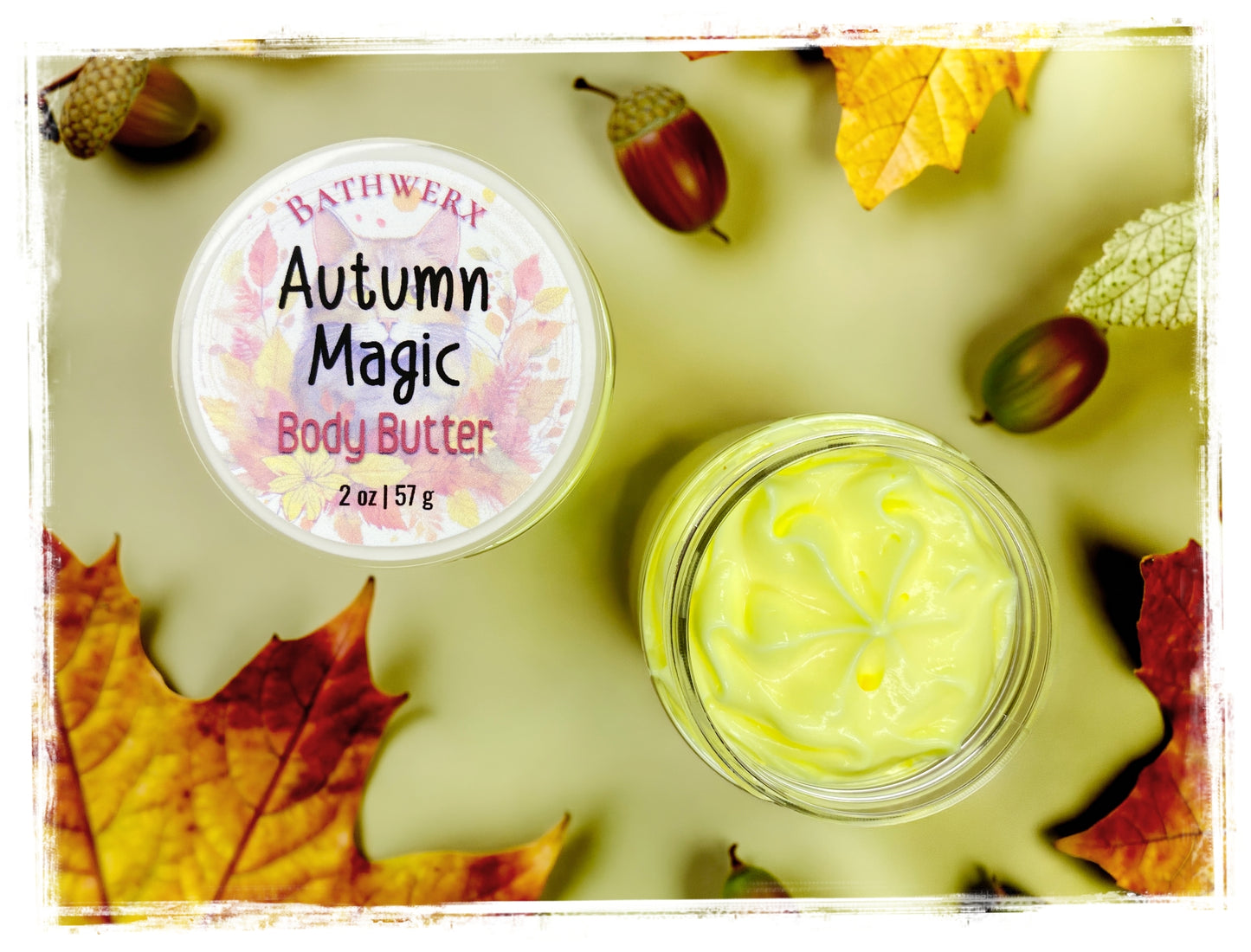 BathWerx Autumn Magic Body Butter open jar and lid, top-down view surrounded by red and yellow maple leaves and acorns - 2 oz whipped body butter
