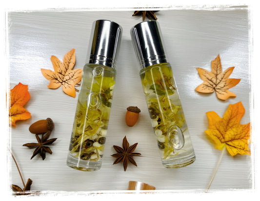 Cocoa Butter Cashmere Fall Roll-On Perfume Oil with botanicals in glass roller bottles styled with autumn leaves and star anise