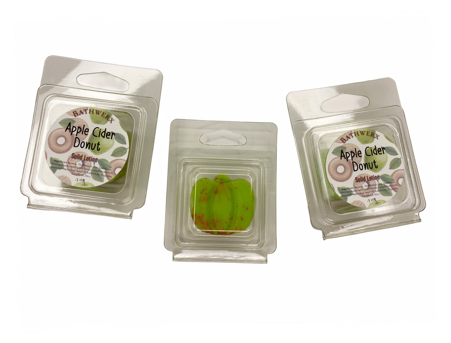 Three BathWerx Apple Cider Donut Solid Lotion bars in clear clamshell packaging with branded labels, center bar shown revealing a green speckled lotion bar - .5 oz