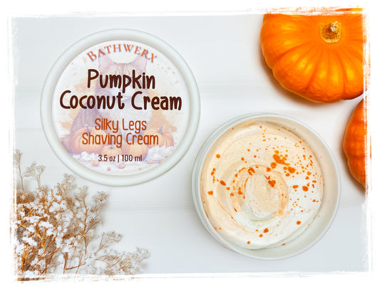 BathWerx Pumpkin Coconut Cream Silky Legs Shaving Cream, 3.5 oz jar with whipped cream texture and pumpkin spice swirl, displayed with orange pumpkins and dried florals