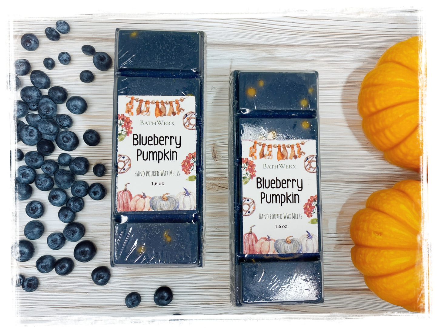 BathWerx Blueberry Pumpkin hand poured wax melts, 1.6 oz, displayed with fresh blueberries and mini pumpkins on a white wood surface.
