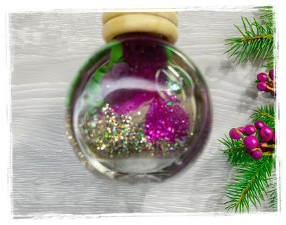 Bayberry Birch Car Charm in a clear glass bottle with rose petals, glitter, and holiday berries.