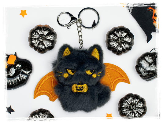 Black and orange plush bat keychain with metal key ring and clasp.